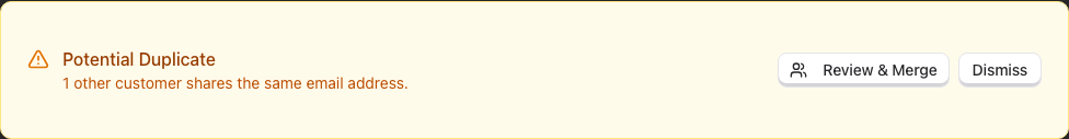 The amber Potential Duplicate panel on a customer profile, reading
