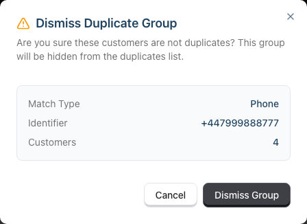 The Dismiss Duplicate Group confirmation dialog showing the match type, identifier and customer count above the Cancel and Dismiss Group buttons